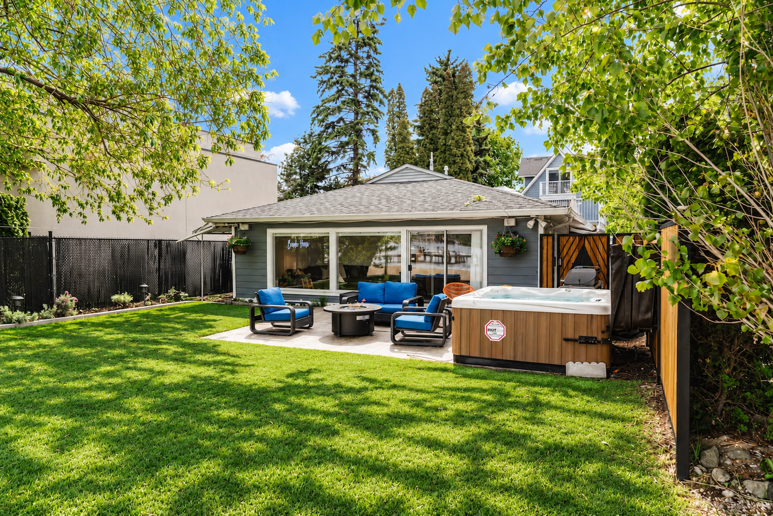 Sunny Downtown Beach House lawn, hot tub and exterior