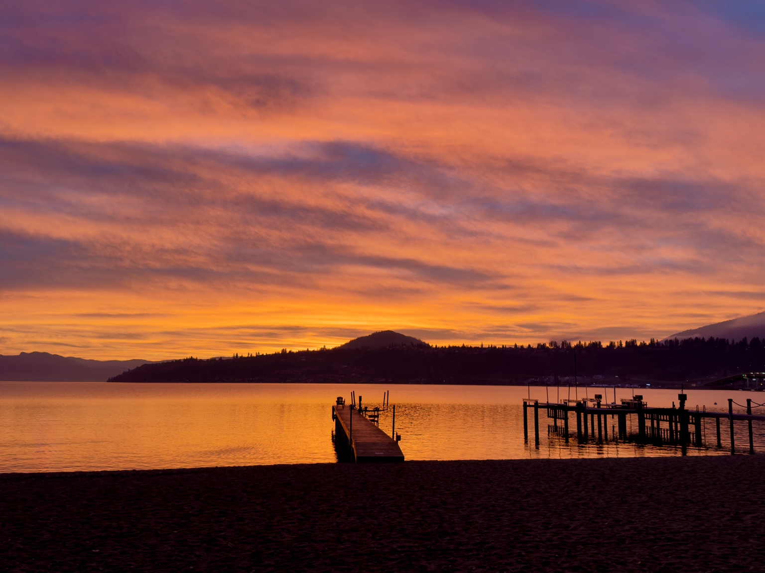 Orange sunset over Okanagan Lake and the private wharf
